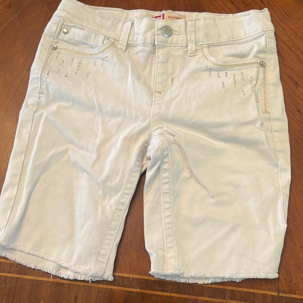White shorts. Cover your thighs. Low rise with adjustable straps. Belt loop.